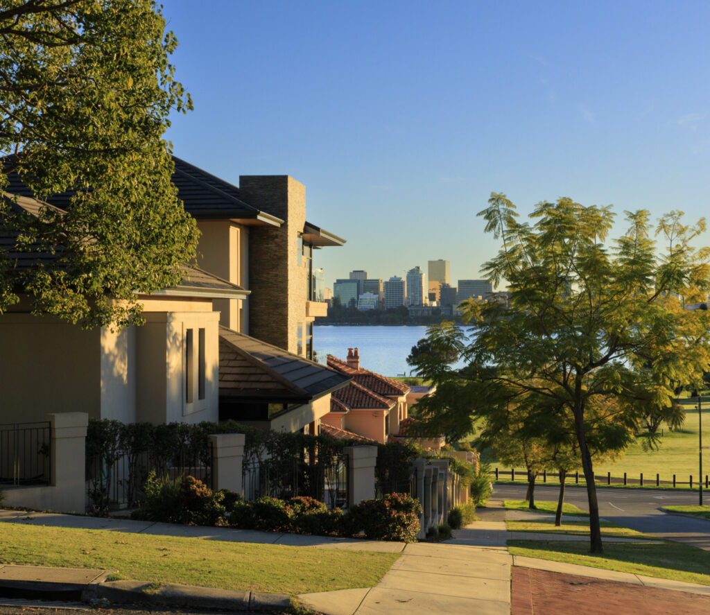 A house overlooking a scenic view of the water and city skyline in the background.